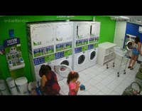 Woman twerks inside laundry shop near children