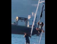 Woman in bikini aerial silk on boat