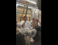 Man drapes his snake onto handrail and lets it hang on the subway