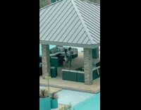 Two women tiktok dance common area poolside