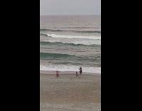 Father and son run at the beach towards the camera Part 1