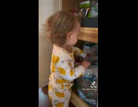 Baby stealing snack out of pantry 