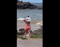 Woman films herself at the beach 