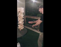Guy karate chops jenga block