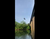 Guy rope swing bridge backflip water 