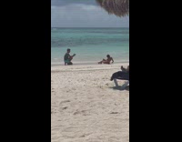 Girl sit on beach gets interrupted couple