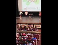 Auditorium blind fold guy touches girl accident