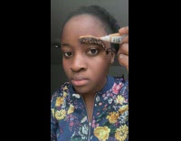 Lady Cuts Hair Extension on Braided Eyebrows
