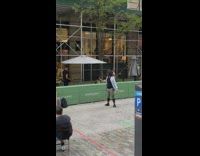 Man curly hair with two bolos laugh near the restaurant