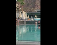 Blue bikini girl stands by pool selfie 
