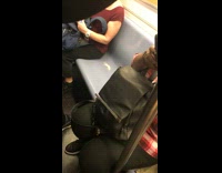 Used condom left on subway seat, woman in red shirt sits near