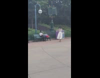 Lady in White Dress Dance as Man Records