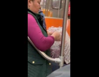 Woman pops bubble wrap inside subway train
