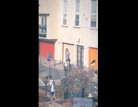 People pose by colorful garage doors