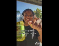  Girl filming herself drinking cooking oil