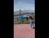 Girl blue pants arch back fence bridge