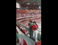 Two girls dance stairs audience Portugal flag