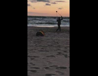 Guy spin offstring yoyo trick  beach sunset
