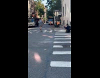 Woman top with fringes poses middle street