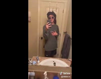 Guy lip syncs bathroom mirror sunglasses beanie 