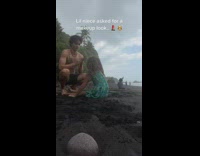 Guy gives little sister makeup with sand