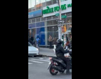 Man rides bicycle balances tire on head
