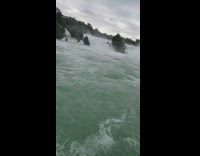 Waterfalls with a strong current filmed on a boat