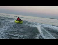 Woman rides yellow inflatable tube, flies off and scorpions into water