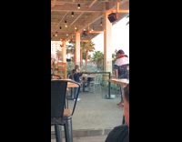 child takes pic of dad at restaurant