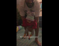 Guy carries baby toward camera 