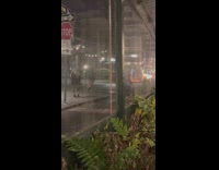 Man holds torch with fire night at street 