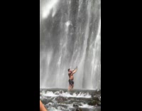 Man shirtless selfie video under the waterfalls