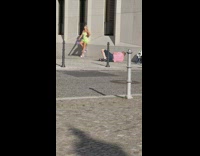 Woman green dress handbag pose beside wall