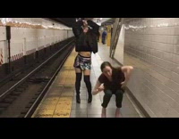 two girls dancing next to subway rails