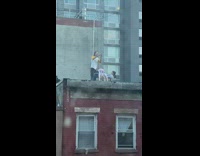 Two women doing backbends one over the other on the roof for a photoshoot