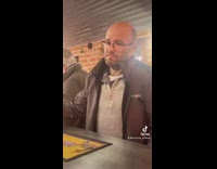 Guy takes sip of beer spits it out