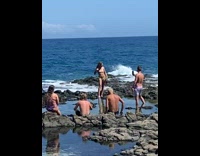 Girl skin tone bikini stand rocky beach