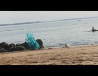 Blue dress matching shawl girl poses beach 