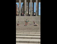 Girls do gymnastic trick picture on stairs 