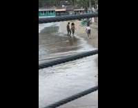 Man woman dance walk beach two cameramen 