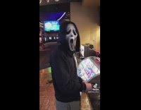 Guy scream mask in movie theater 