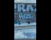 Shirtless man and woman dance street snow