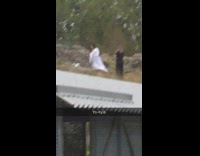 Women dress jumps down hill and takes picture