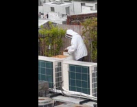 Person protective suit bee farm on rooftop