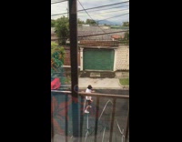 Black bucket hat guy dances neighborhood street 