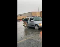 Guy jumps on chair to avoid getting wet in flooded parking lot 