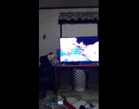 Girl sits on black crate and falls down after pushing it