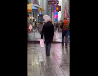 Guy walking in rain with plastic bag over head