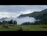 Thick fog covers the mountains in a time lapse