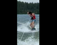 Guy shotguns beer wakeboard red life vest